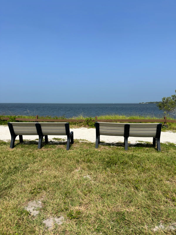 Two benches along the trail with a view of the ocean