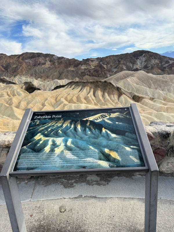 Zabriskie Point mountains and an informational sign