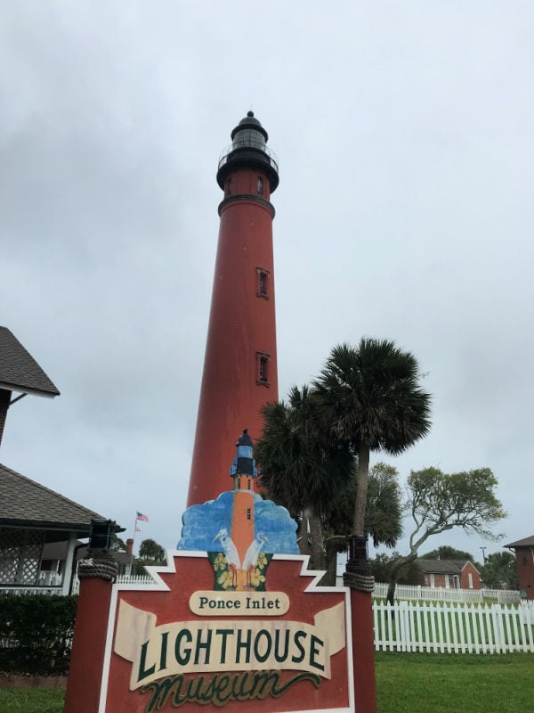 Ponce Inlet Lighthouse with a sign in front of it for the museum