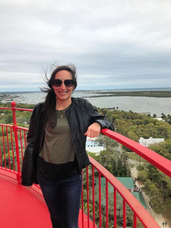 Me smiling with my hair blowing in the wind at the top of the St. Augustine Lighthouse